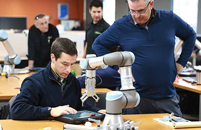 Members working on robotics during the Universal Robots training